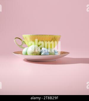 Spring Serenade: A Whimsical Yellow Teacup with Easter Eggs in Pastel Colors Stock Photo