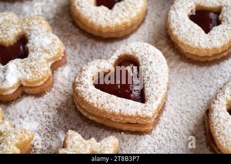 Heart shaped Linzer Christmas cookie filled with strawberry marmalade and dusted with sugar, closeup Stock Photo