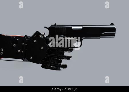 Real robot's hand with handgun. Concept of AI takeover and technological singularity Stock Photo