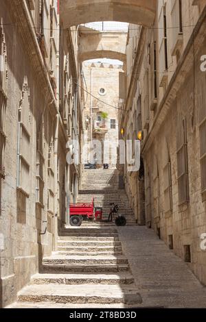 The narrow alley called Adabat el-Rahbat, or The Nuns Ascent, just off the Via Dolorosa, Old City of Jerusalem, Israel. Stock Photo