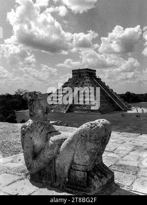 Mexico, Yucatan, Chichen Itza:The Mayan Chac Mool statue in the foreground and the pyramid of Temple of the Warriors in the background Stock Photo