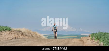 Single Bicyclist on Rural Road Stock Photo