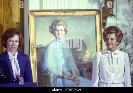 **FILE PHOTO** Rosalynn Carter Has Passed Away. First lady Rosalynn Carter, left, and former first lady Betty Ford pose next to the portrait of Mrs. Ford that was unveiled during a ceremony in the East Room of the White House in Washington, DC on August 4, 1980. The painting will be on permanent display at the White House along with those of other US Presidents and first ladys. Credit: Benjamin E. 'Gene' Forte/CNP /MediaPunch Stock Photo