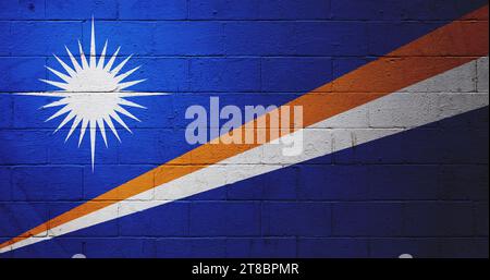 Flag of the Marshall Islands painted on a cinder block wall. Stock Photo