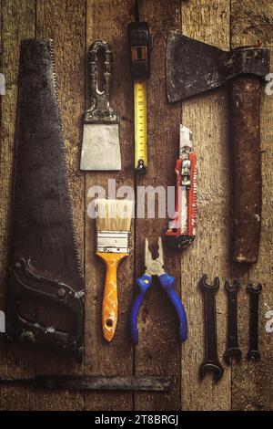 Old and dirty construction tools on wooden background Stock Photo