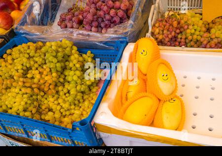 A variety of fresh fruits and vegetables on display at the market. Stock Photo