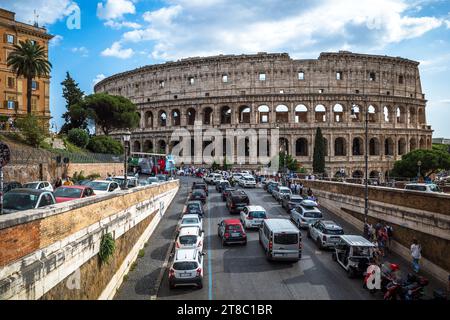 View of the Colosseum in Rome with crowds of tourists walking in the ...