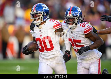 New York Giants' Deonte Banks, left, and Xavier McKinney, right, break ...