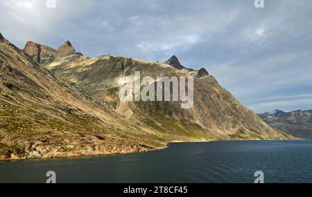 the steep, glaciated granite peaks of the western side of the prince christian sound, in southern greenland, from a cruise ship Stock Photo