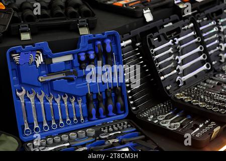 Tool kits in plastic boxes on the showcase of tool store. Selective focus. Stock Photo