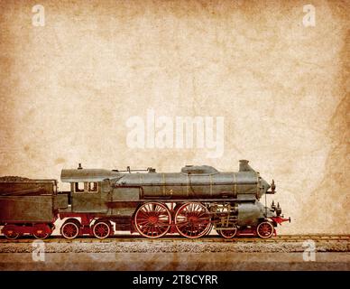 Antique model of old train locomotive isolated on old antique vintage paper background Stock Photo