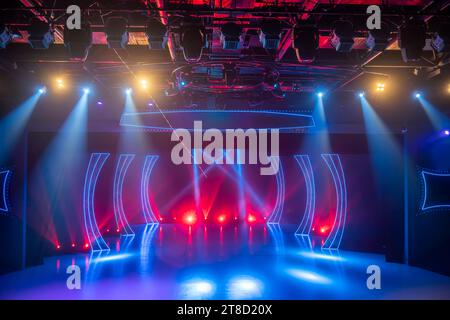 Checkered scene with laser beams, lamps and swirling smoke, disco dancing area interior Stock Photo