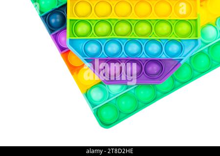 Pop it antistress close-up. Modern antistress toy. Background from rainbow toys. Stock Photo