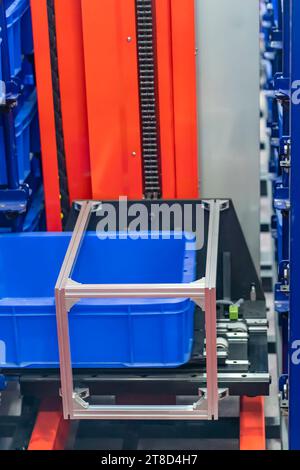 plastic boxes in the cells of the automated warehouse. Metal construction warehouse shelving Stock Photo