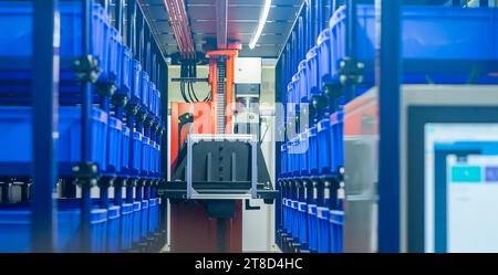 plastic boxes in the cells of the automated warehouse. Metal construction warehouse shelving Stock Photo