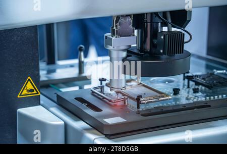 The multi-axis CMM machine measure the aluminum mobile phone part . Stock Photo