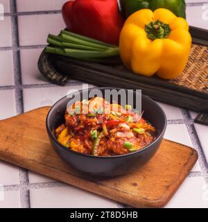 Fresh chilli fish food,Food thai chilli fish in black bowl white background. Stock Photo