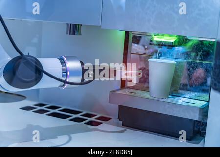 robotic arm preparing coffee in coffee machine Stock Photo
