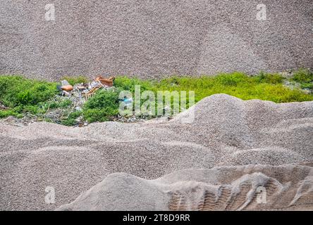 Garbage and rubbish, bricks, fragments of building in pile of sand on a construction site Stock Photo