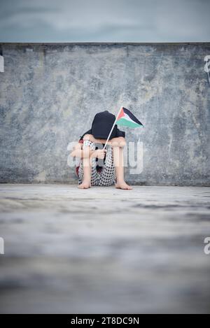 Cute Little girl waving Palestine Flag sends a powerful message of support and empathy to the world Stock Photo