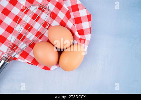 Close - up raw chicken eggs with tablecloth on wooden background. Stock Photo