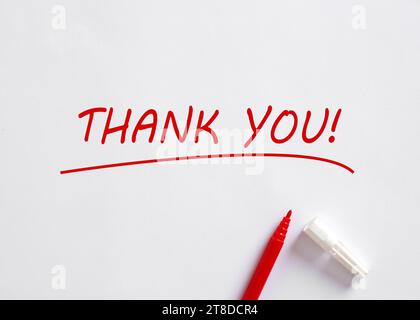 Hand written Thank You message with a red pen on white background. Gratitude concept. Stock Photo
