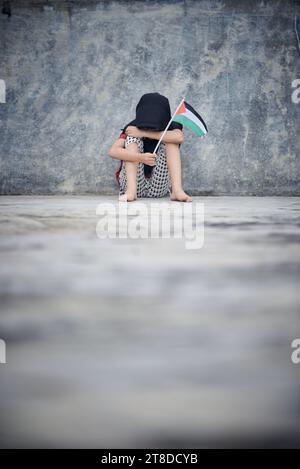 Cute Little girl waving Palestine Flag sends a powerful message of support and empathy to the world Stock Photo