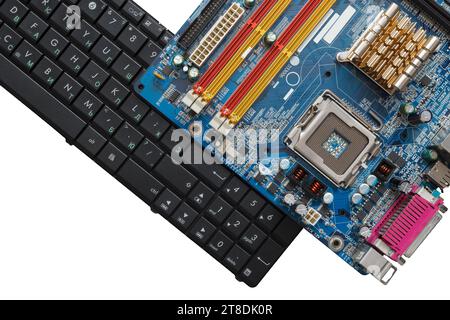 Computer keyboard and motherboard isolated on white background. Repair, assembly of personal computer Stock Photo