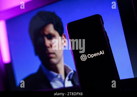 OpenAI logo and Sam Altman in background on screen. OpenAI fires CEO Sam Altman Stock Photo