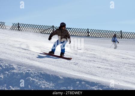 KAPRUN, AUSTRIA - MARCH 5, 2012: Unidentified snowboarder snowboarding down the slope in the Austrian Alps, in Kitzsteinhorn Stock Photo
