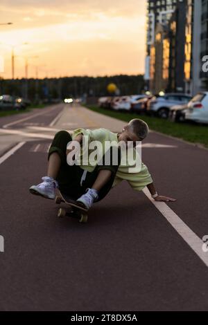 A young woman rides a longboard along the city streets. Stock Photo