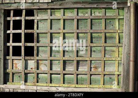 Grille in an old house. Old grille on the window. Steel cage. Stock Photo