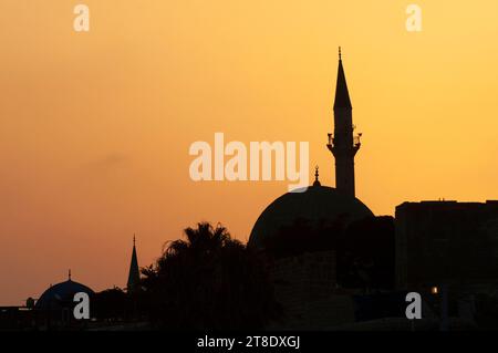 Sunset silhouette of the El-Jazzar Mosque and minaret, also known as the White Mosque, in the Israeli city of Acre/Akko/Acco. Stock Photo