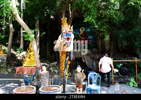 Ancient hermit or antique eremite statues for thai people travelers respect praying blessing myth mystery of Wat Tham Nam or Water Cave Temple at Phot Stock Photo