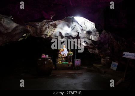 Ancient old hermit or antique eremite statues for thai people travelers respect praying blessing myth mystery in cavern of Wat Tham Nam or Water Cave Stock Photo