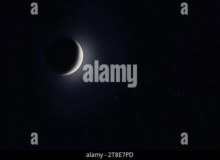 Waxing Crescent moon glowing taken November 16, 2023 above Ottawa, Canada against a starry black background. Stock Photo
