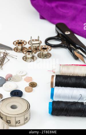 Vertical photo, sewing material presented on a white table, for manual textile works. Stock Photo