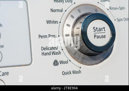 The Details of a Washing Machine Selector knob focus on the Start Pause button Stock Photo