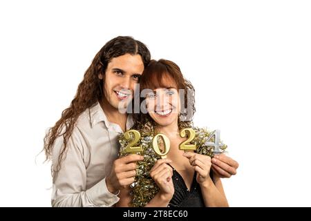 Horizontal medium close up photo Caucasian couple mid adult, embracing, elegant dresses. Celebrating new year 2024. White background. Copy space white Stock Photo