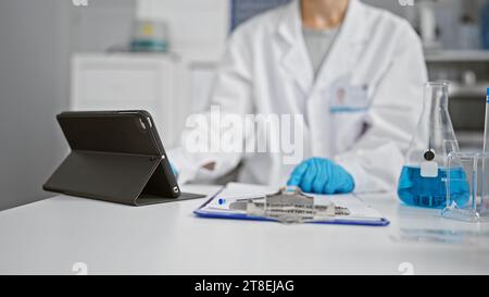Hands of woman scientist using touchpad at laboratory Stock Photo