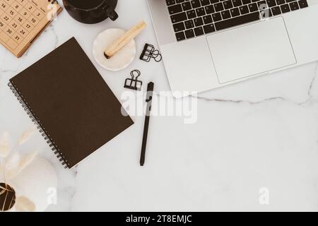 White desk office copy space with laptop, stationery and notepads, cup of tea and palo santo flat lay. Top view. Copy space. Modern aesthetic workspac Stock Photo