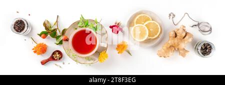 Tea with herbs, fruits, and flowers panorama, overhead flat lay shot on a white background. Healthy natural remedy Stock Photo