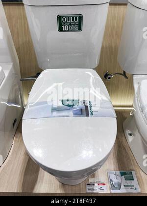 Ceramic toilet bowls of various shapes and sizes in the trading floor of a chain store. Bekasi, Indonesia, November 20, 2023 Stock Photo