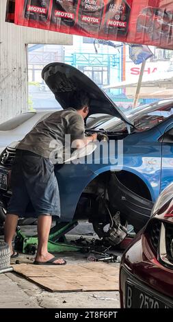 Car care maintenance and servicing, Close-up hand technician auto mechanic using the wrench to repairing. Stock Photo