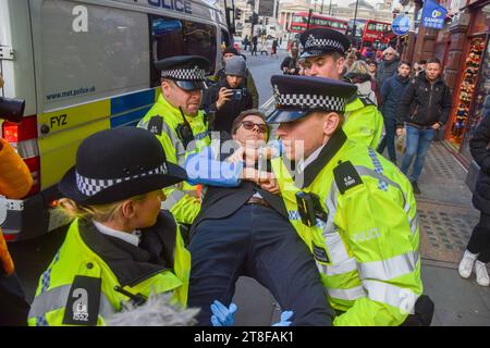London, England, UK. 20th Nov, 2023. Police officers arrest Just Stop Oil activists in Whitehall near Trafalgar Square several minutes after they began their march, as the climate action group continue their protests against new fossil fuel licences. (Credit Image: © Vuk Valcic/ZUMA Press Wire) EDITORIAL USAGE ONLY! Not for Commercial USAGE! Stock Photo