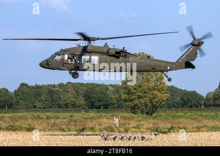 82nd Airborne Division infantry soldiers on the ground and a US Army UH-60 Blackhawk helicopters during Operation Market Garden Memorial exercise. Gra Stock Photo