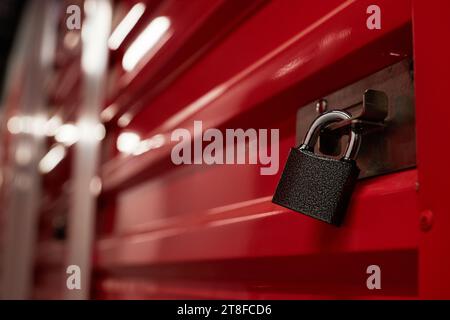 Padlock on closed red metal door in warehouse Stock Photo