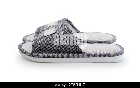 The pair of new textile house slippers isolated on white. Stock Photo
