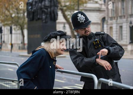 Met policemen helping elderly lady with directions, London, England, UK Stock Photo
