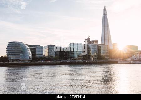 Golden sunset over the Thames with the silhouette of The Shard and other buildings in London, UK. Stock Photo